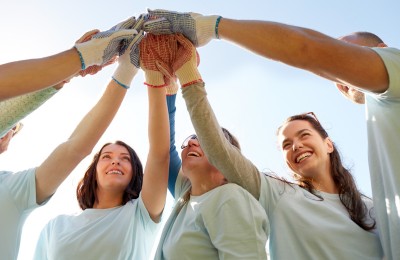sports team of people all touching hands in the circle