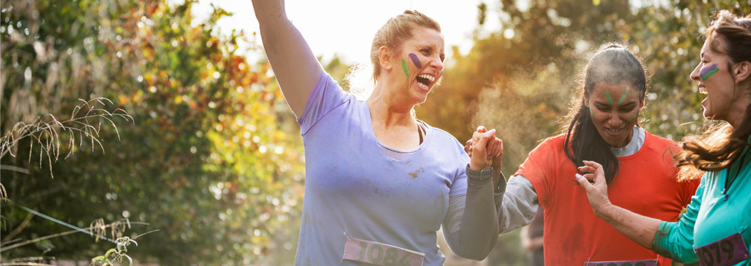 Fundraisers participating in outdoor sports event and cheering enthusiastically