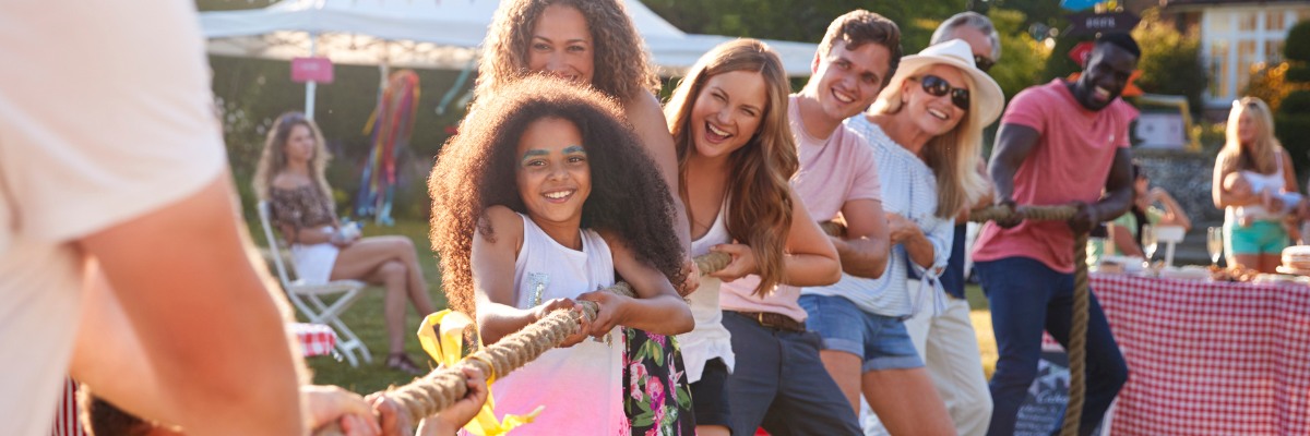 Fundraising event image showing community group playing tug of war at a fete