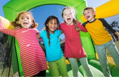bouncy castle with 4 happy children