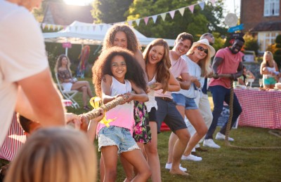 fundraising fete showing people playing tug of war