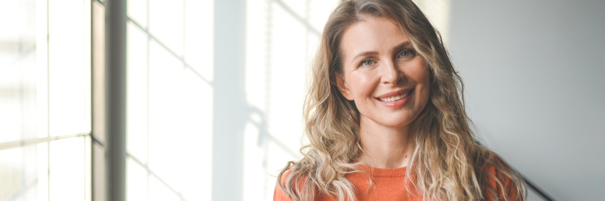 Happy middle aged woman looking at camera
