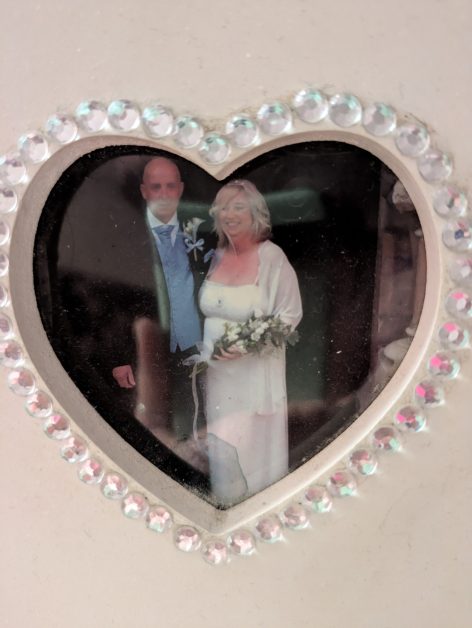 Heart shaped photo of Andy and Veronica dressed up on their wedding day