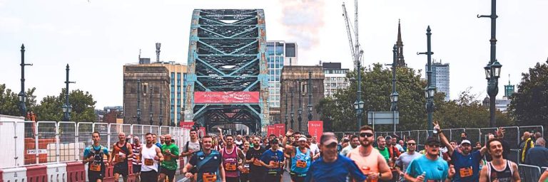 Great North Run - image shows marathon runners crossing a bridge