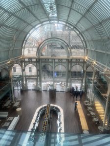 Photo of the inside of the Royal Opera House foyer, showing vaulted ceilings and huge windows.