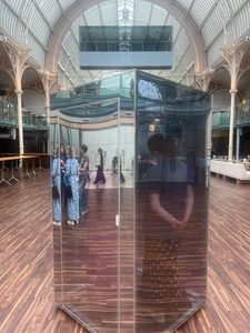 Photo of the Mirrorbox, a reflective box cpvered in mirrors, big enough for a person to step inside, placed in the Royal Opera House.