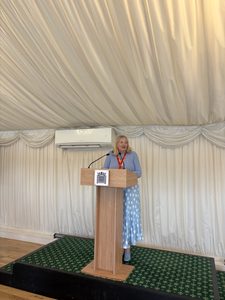 IMAGE DESCRIPTION: Photo of Katrina Burchell giving at talk at a podium.